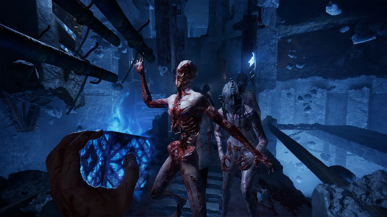 Two flayed, bloody figures advance through a blue-lit stone ruin while a glowing box is held up in the foreground