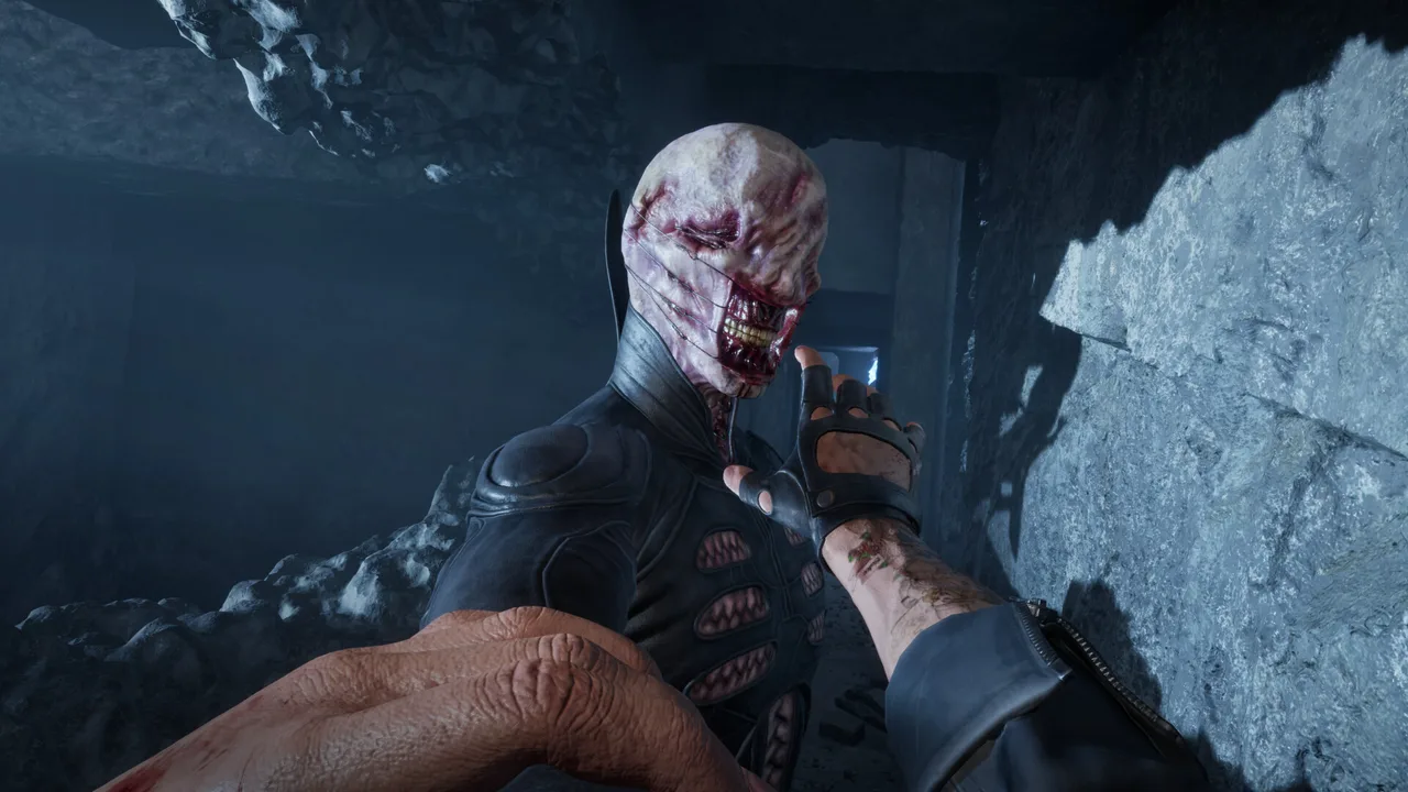 A pale creature with a torn, grinning face leaning in close