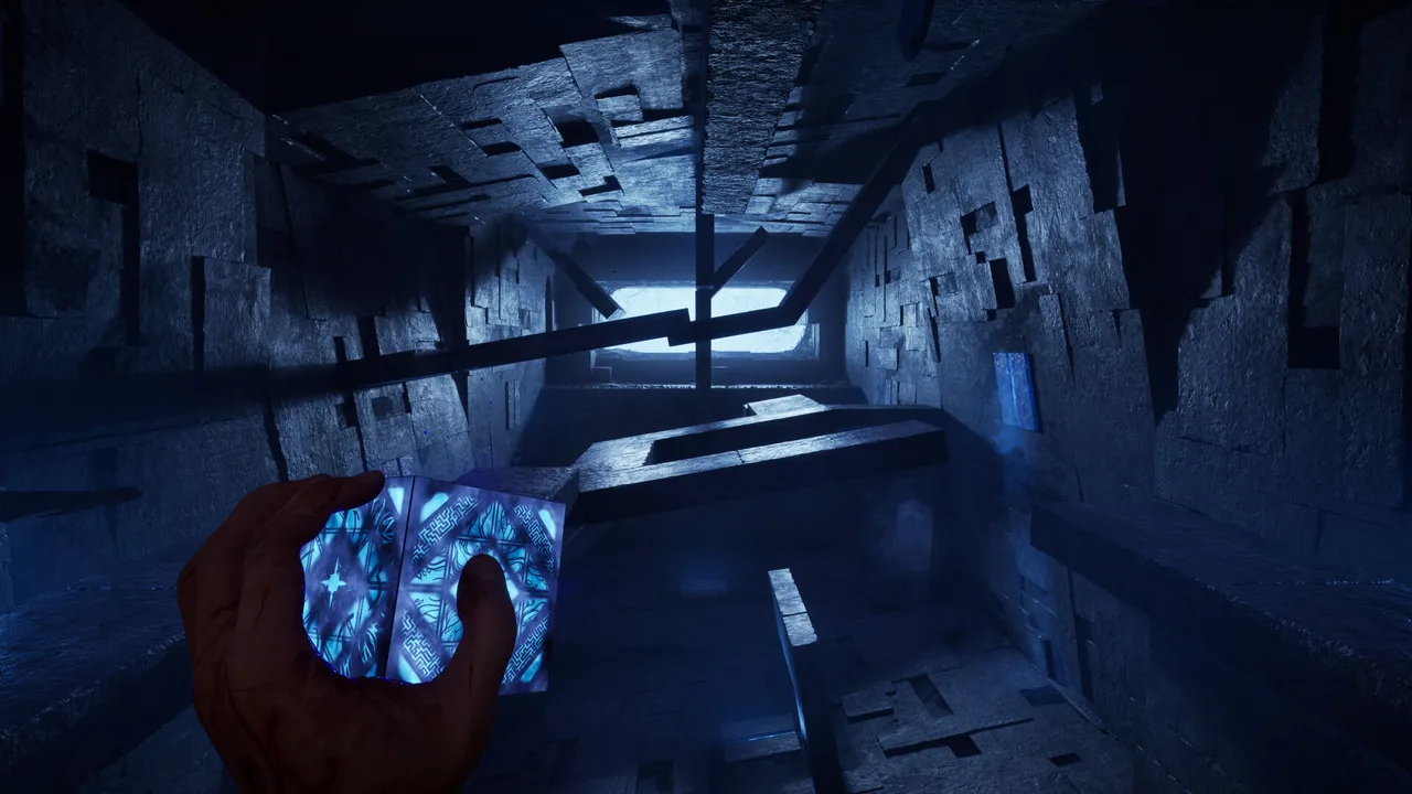 First-person view down a corridor of shifting stone blocks lit in blue, a glowing box held in one hand